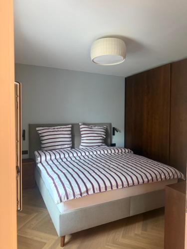 a bedroom with a large bed with a light at Dolce Vita Appartment in Schärding