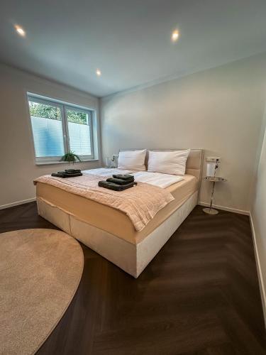a bedroom with a large bed with a window at LUMEA Devin in Stralsund