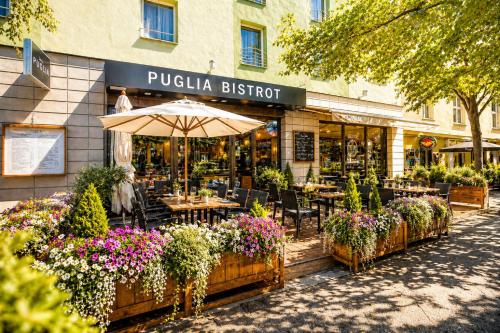 a restaurant with tables and flowers in front of it at Plaza Boutique Hotel - Czech Leading Hotels in Prague