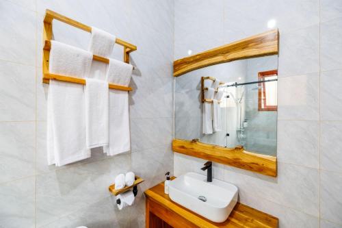 a bathroom with a sink and a mirror at Chui hidden Lodge Karatu in Karatu