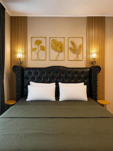 a bedroom with a large bed with two white pillows at Bali Queen Cottage in Pabean Buleleng