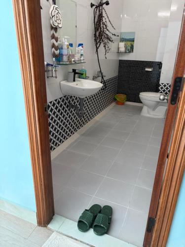 a bathroom with a toilet and a sink at Anhbnb in Danang