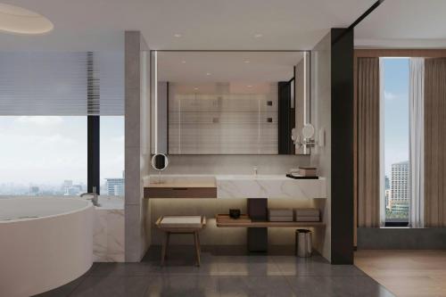 a bathroom with a bath tub and a sink and a bath tub at Fairfield by Marriott Kunming Xishan in Kunming
