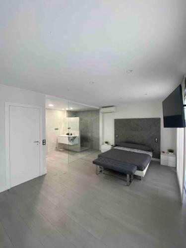a bedroom with a bed and a television in it at Entire 250m2 chalet in Puzol