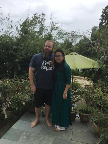 a man and a woman standing next to each other at Flame Flowers Homestay in Hoi An