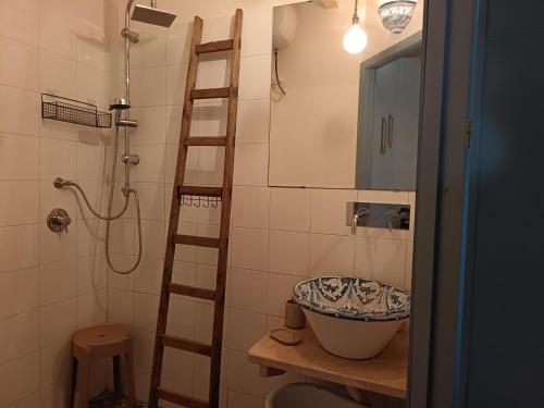 a bathroom with a ladder and a sink and a shower at Agri Experience - Case Gentile in Castelvetrano Selinunte