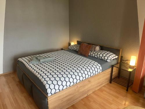 a bedroom with two beds and two lights on at Apartman QUATTRO in Sokolov