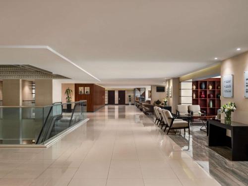 a lobby of a hospital with chairs and tables at Anwar Al Madinah Mövenpick in Medina