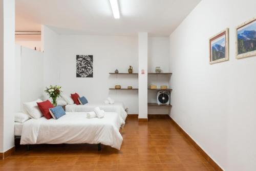 a white room with two beds and a couch at Vv Casa Marire in Breña Alta