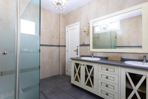 a bathroom with two sinks and a mirror at house las chuchas CALAHONDA in Motril