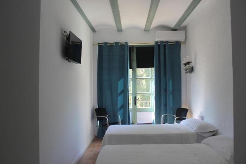 a hospital room with two beds and a window at Lotel Casa Noble in Valencia