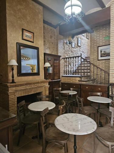 a restaurant with tables and chairs and a fireplace at Lotel Casa Noble in Valencia