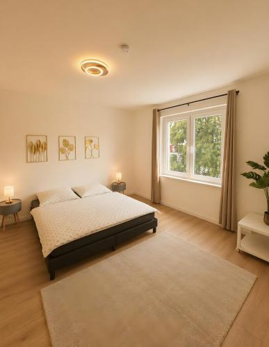 a bedroom with a bed and a large window at Theaterblick Hildesheim in Hildesheim