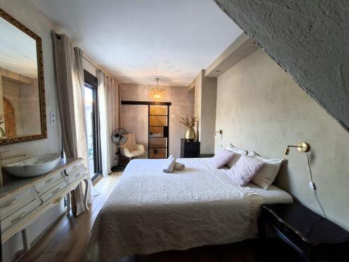 a bedroom with a large bed and a sink at Villa Torre Macastre, Valencia in Macastre