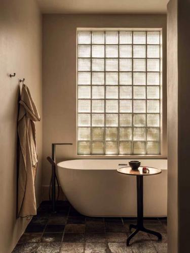 a bath tub in a bathroom with a window at is.land Villa in Sanya