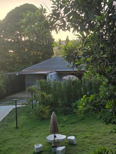 a house with a table in front of a yard at Golden Villa in Ko Phangan
