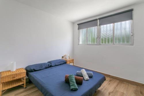 a bedroom with a bed and a large window at Casa di soza in Busot