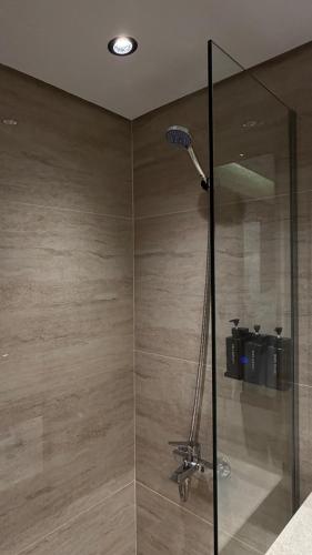 a shower with a glass door in a bathroom at The Business Hotel By Seafront فندق ذا بيزنس in Jeddah
