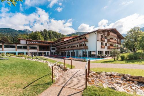 a resort with a pool and a building at Das Bayrischzell Familotel Oberbayern in Bayrischzell