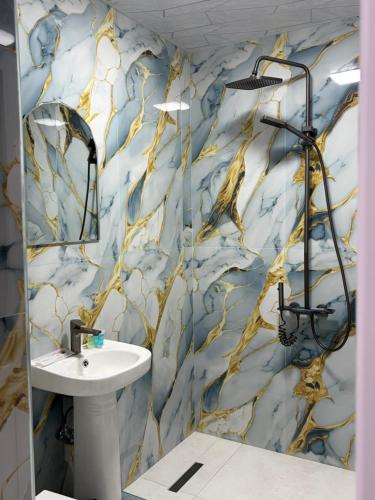 a bathroom with a blue and gold wallpaper at Cascade Resort Sevan in Sevan