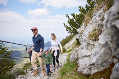 a family walking on a mountain trail at Das Bayrischzell Familotel Oberbayern in Bayrischzell