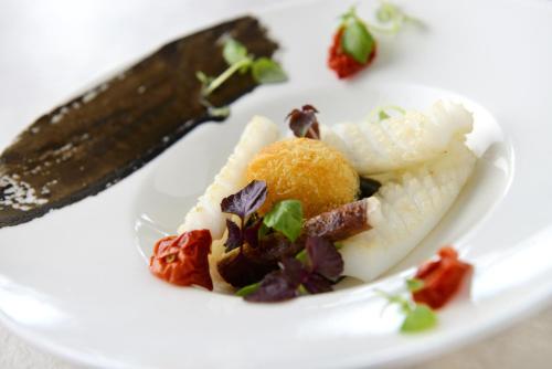 a white plate with some food on it with a knife at Amakusa Tenku No Fune in Kami Amakusa