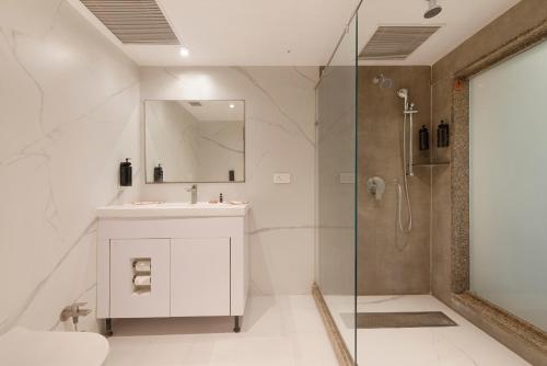 a bathroom with a sink and a shower at Ginger Agra, Fatehabad Road in Agra