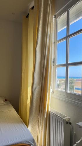 a bedroom with a bed and a window at Villa Korba 2nd Floor in Korba