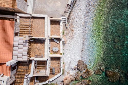 an overhead view of a building next to the water at Aura Seafront Villa in Neo Itilo