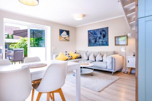 a living room with a table and a couch at Ülleken in Fehmarn