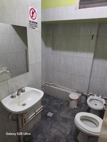 a bathroom with a toilet and a sink at Hotel Roy's in San Juan
