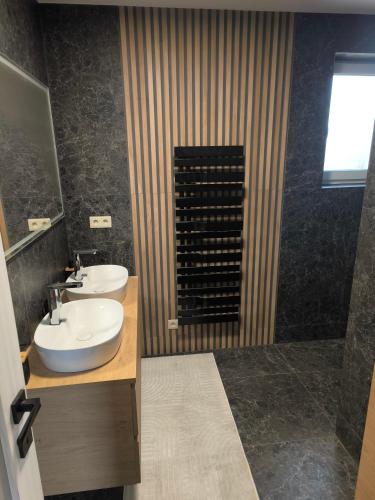 a bathroom with a sink and a shower at Dubrowes cottage in Bobrów