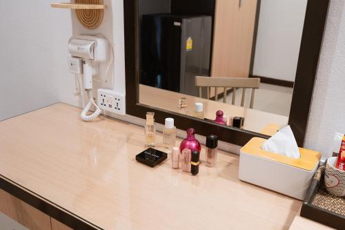 a counter with bottles of cosmetics sitting on it at JT Place Buriram in Buriram