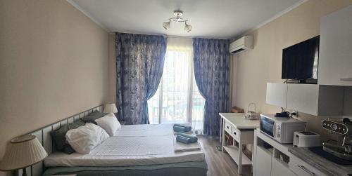 a small room with a bed and a window at Sun Sea 1 studio sea view in Shkorpilovtsi