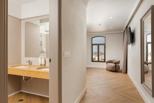 a bathroom with a sink and a mirror at B&B HOTEL Sado Setúbal in Setúbal