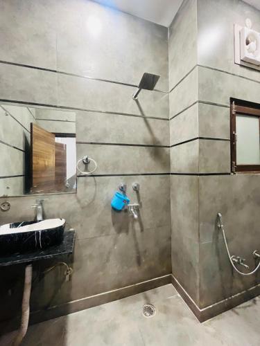a bathroom with a sink and a shower at Hotel Royal Residency - Laxmi Nagar in New Delhi