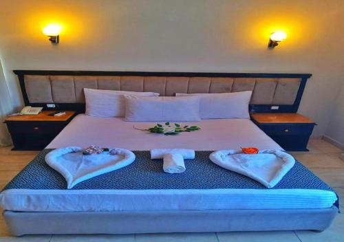 a bedroom with a bed with towels on it at DaVinCi hotel in Hurghada