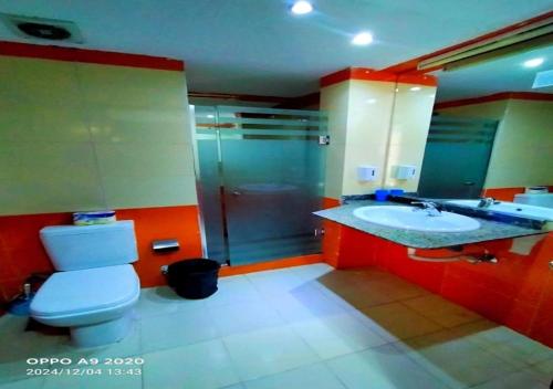 a bathroom with a toilet and a sink and a shower at DaVinCi hotel in Hurghada