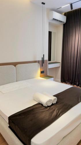 a bedroom with a large bed with a towel on it at Apt Elite in Khujand