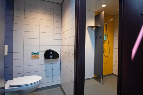 a bathroom with a toilet and a shower at Stayokay Hostel Rotterdam - fully renovated April 2026 in Rotterdam