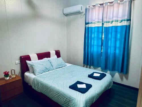 a bedroom with a bed with two blue dishes on it at Apartment in Port Moresby - Short Stays in Port Moresby