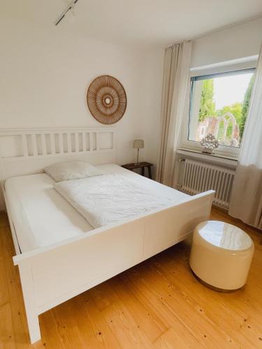 a white bed in a room with a window at Ferien in der Flurstraße in Velbert