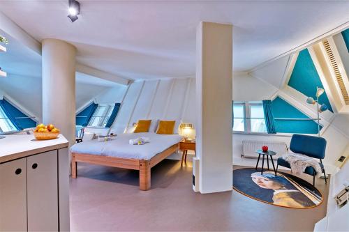 a room with a bed and a table in a room at Stayokay Hostel Rotterdam - fully renovated April 2026 in Rotterdam