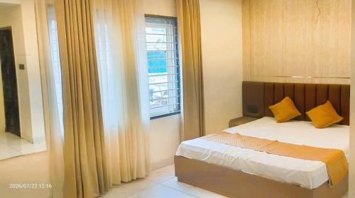 a bedroom with a bed and a window at Vista10 in Bhopal