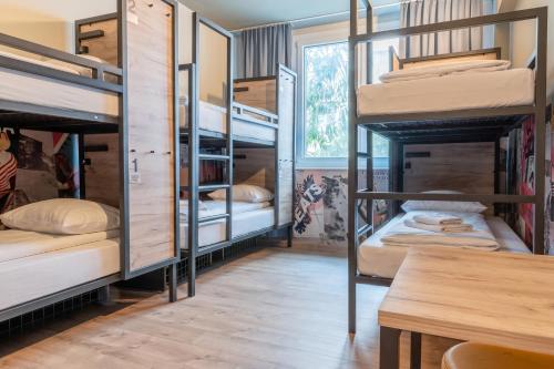 a room with four bunk beds and a table at a&o Hostel Venezia Mestre in Mestre