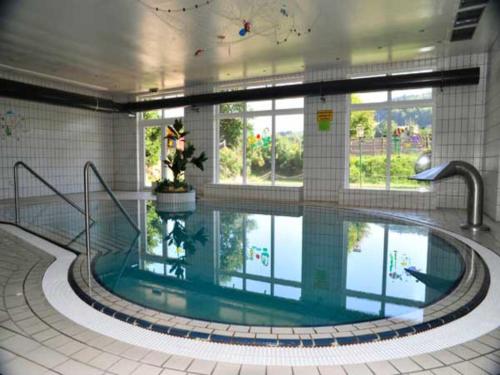 a large swimming pool in a building at Appartement mit All inklusive Angebot und Pool in Runding
