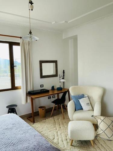 a bedroom with a desk and a chair and a bed at Hostel Calao in Shkodër