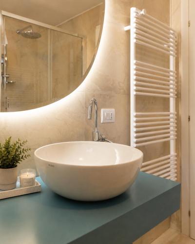 a bathroom with a white sink and a mirror at View & Chill Apartment in Riva del Garda