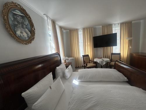 a hotel room with two beds and a television at DREI SEEN HOTEL BRANDENBURG in Lindow Ratskeller in Lindow