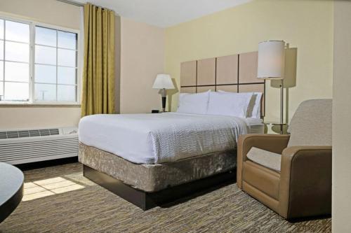 a hotel room with a bed and a couch at Candlewood Suites Killeen - Fort Hood Area by IHG in Killeen